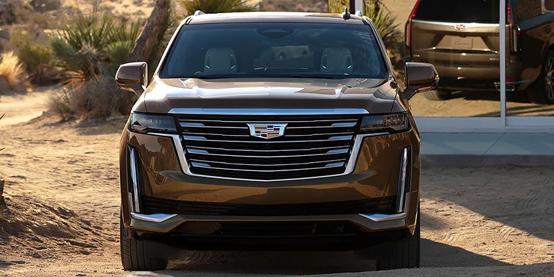 Front view of a Cadillac Escalade, showcasing its bold grille, sleek headlights, and luxury design.
