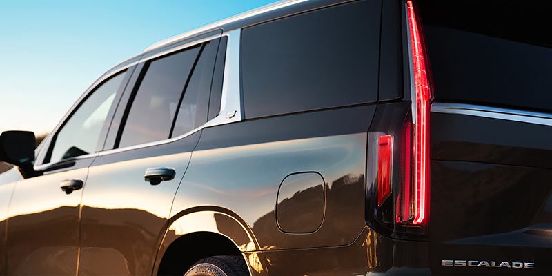 Side view of a Cadillac Escalade, highlighting its sleek profile and detailed tail lamp design