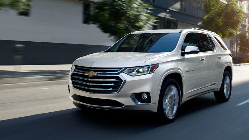 Chevrolet Traverse driving on a road, surrounded by scenic views.