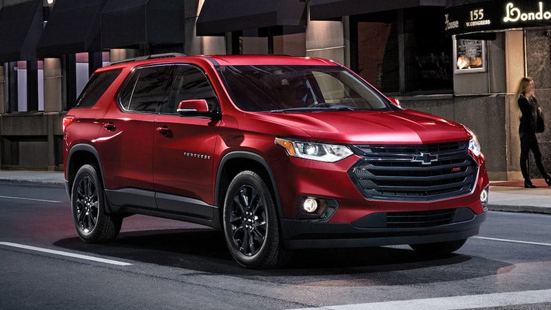"Side view of a red Chevrolet Traverse, showcasing its sleek design and bold features.