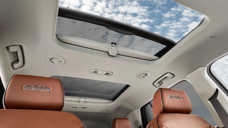 Chevrolet Traverse with its sunroof open, offering a clear view of the sky.