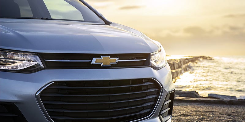 Front view of a Chevrolet Trax, highlighting its bold grille, headlights, and compact design.