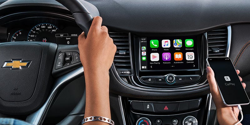 Close-up of the Chevrolet Trax dashboard, featuring the infotainment system, steering wheel, and modern controls.