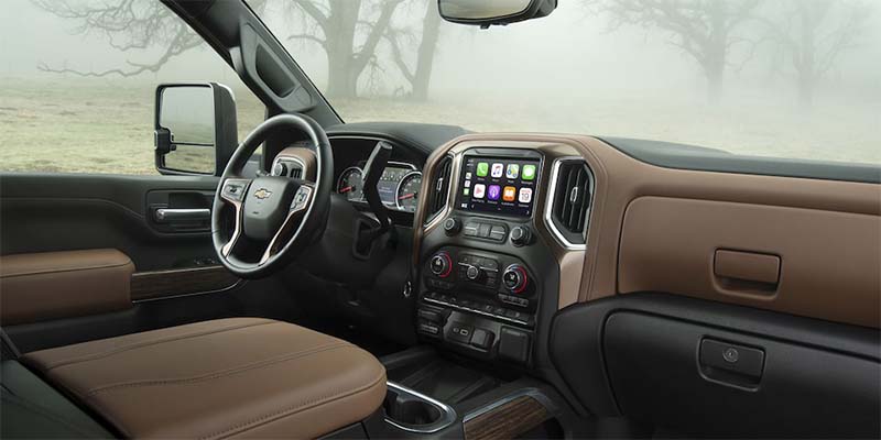 Interior of a Chevrolet Silverado 2500HD, featuring a spacious cabin, modern dashboard, and durable seating.